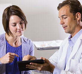 Woman talking to doctor