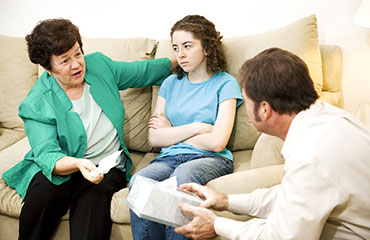 Girl talking with parents on the couch