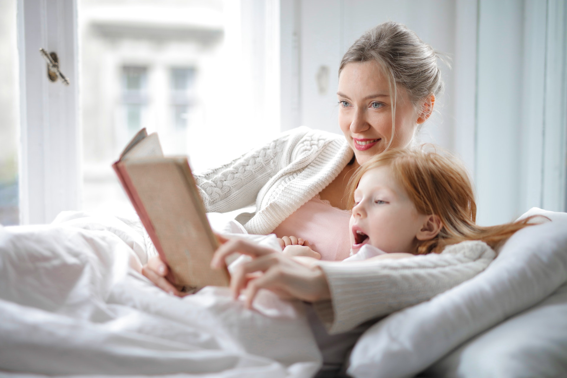 a mother reading bedtime affirmations to her child